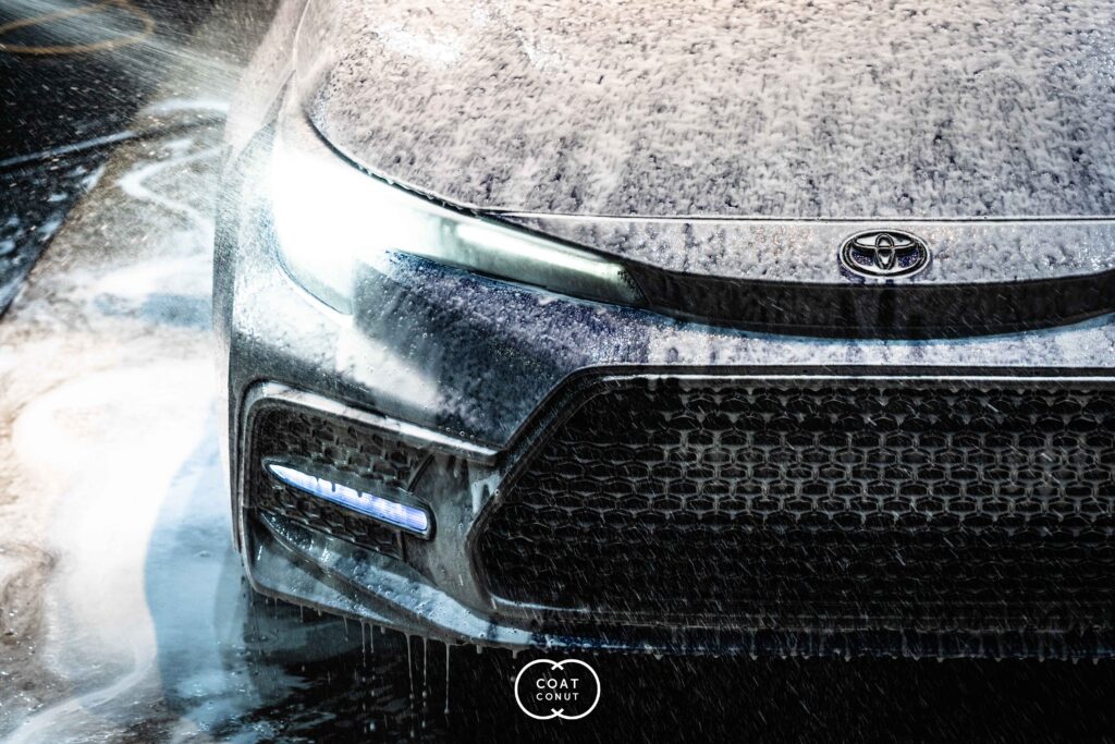 Toyota GR covered in thick foam during a foam cannon wash