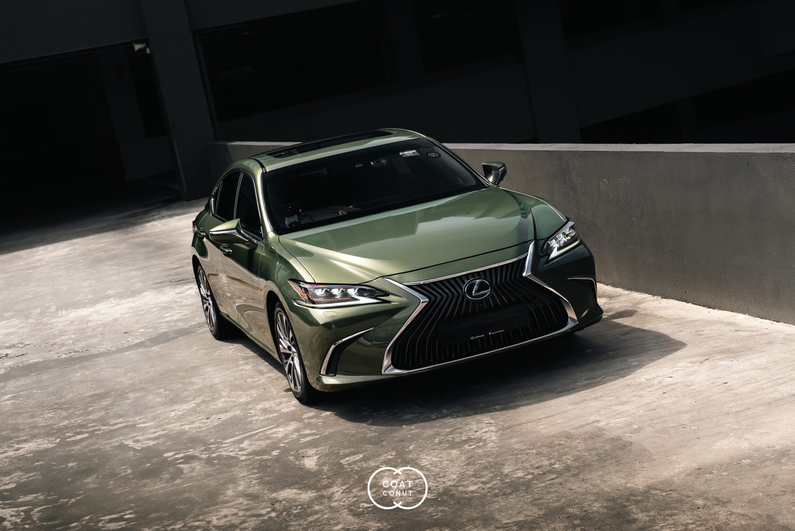 Lexus ES300h in a khaki green full colour-change wrap, parked in shadow